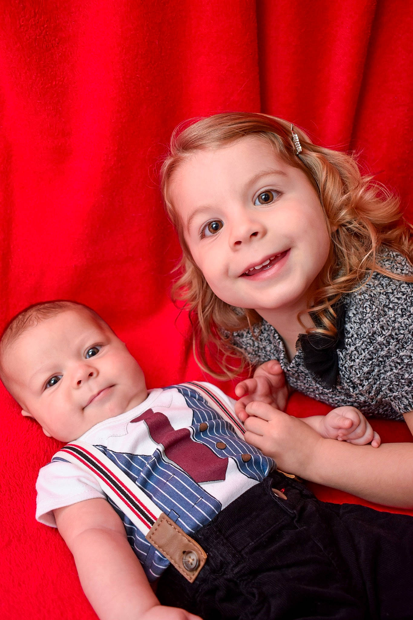 Emily is registered to the contest to win money with this photo: baby, baby_toddler_clothing, beauty, blond, child, comfort, event, facial_expression, fun, gesture, happy, iris, joy, lap, pattern, person, red, sitting, skin, sleeve