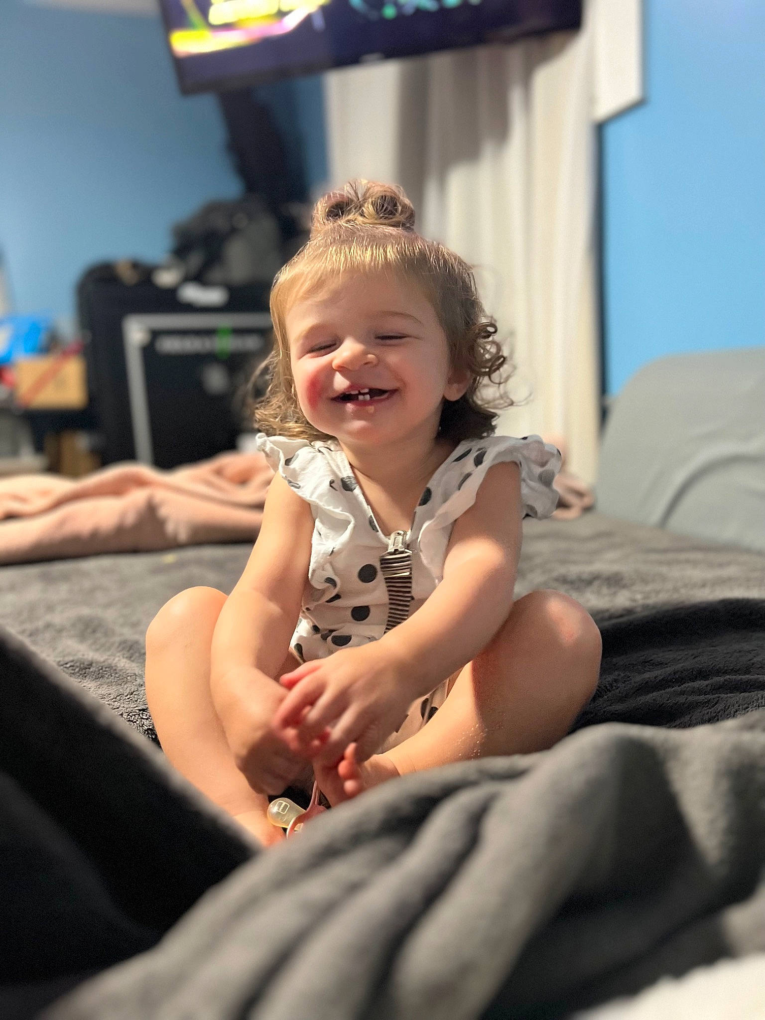 Halston is registered to the contest to win money with this photo: child, comfort, event, flash_photography, flooring, foot, fun, happy, human_leg, joy, knee, laugh, leisure, person, recreation, room, sitting, smile, television, thigh