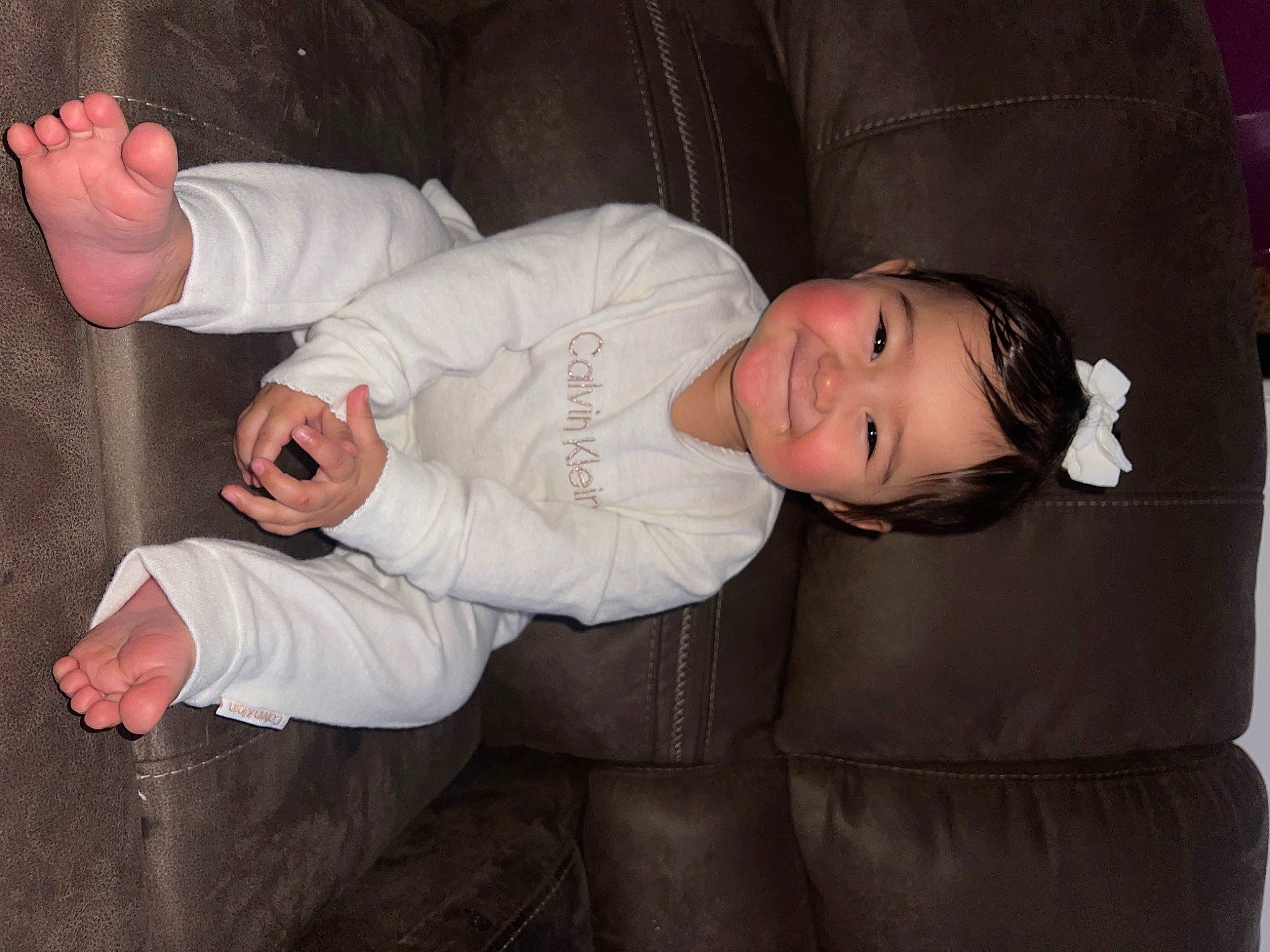 Lenaya is registered to the contest to win money with this photo: baby, baby_toddler_clothing, child, collar, comfort, couch, cuff, fun, gesture, hat, headgear, joy, person, sitting, skin, sleeve, thumb, toddler, wood, wrist