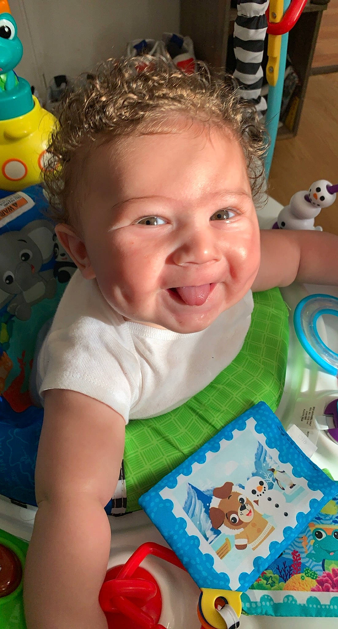 Dennis is registered to the contest to win money with this photo: baby, baby_playing_with_toys, baby_toddler_clothing, cheek, child, facial_expression, fun, hairstyle, happy, head, iris, mouth, nose, person, product, room, skin, sleeve, smile, t_shirt