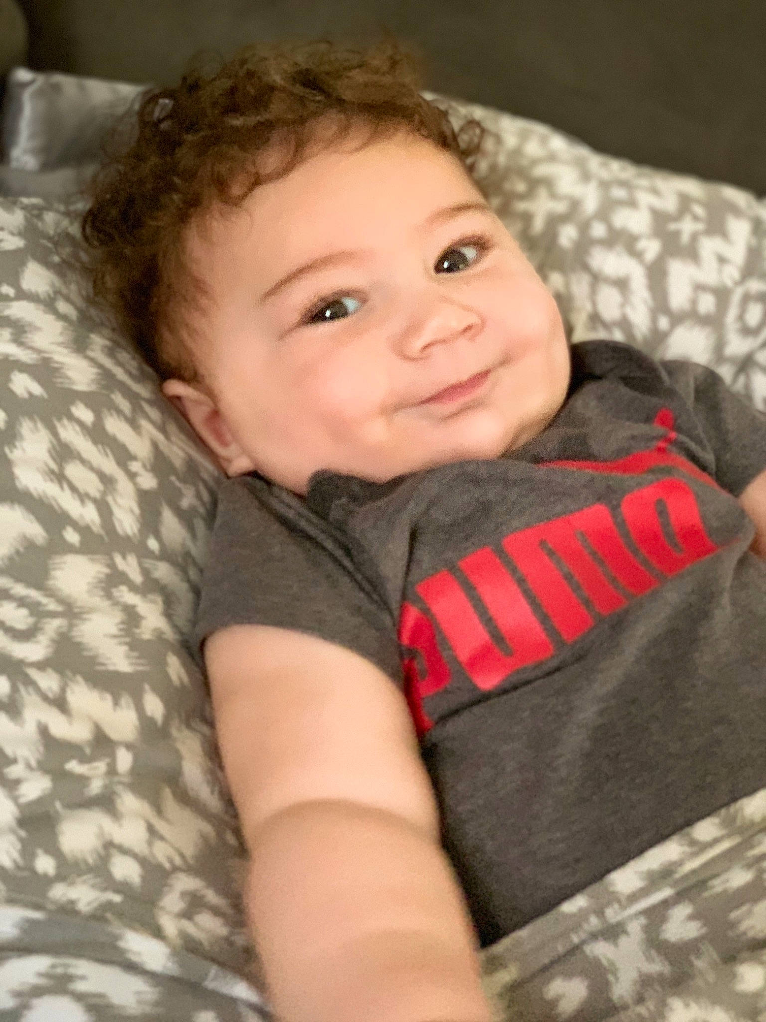 Dennis is registered to the contest to win money with this photo: arm, baby_toddler_clothing, cheek, chin, comfort, eye, facial_expression, flash_photography, happy, iris, joy, lip, mammal, mouth, nose, person, skin, sleeve, smile, t_shirt