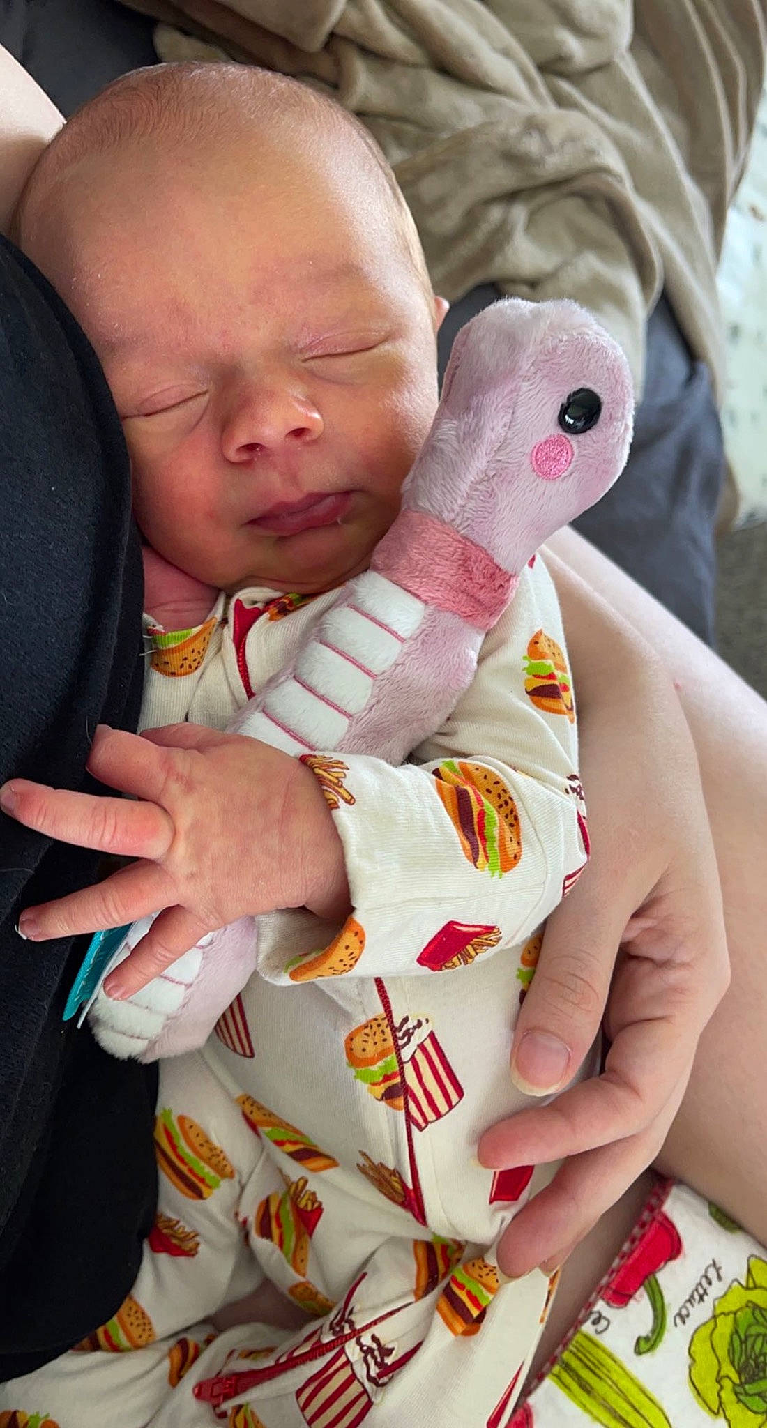 Zedric is registered to the contest to win money with this photo: baby, baby_products, baby_toddler_clothing, carmine, child, comfort, finger, gesture, hand, happy, linens, nail, pattern, person, pink, skin, stuffed_toy, thumb, toddler, white