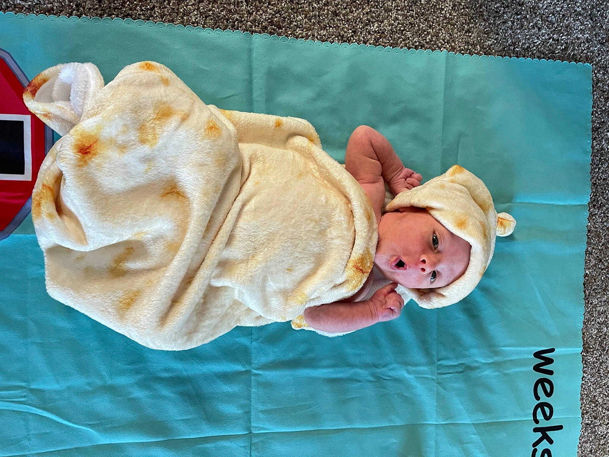 Zedric is registered to the contest to win money with this photo: baby, baby_products, baby_toddler_clothing, child, fashion_accessory, fawn, hand, hat, headgear, headwear, linens, pattern, peach, person, pink, product, room, sun_hat, textile, toddler