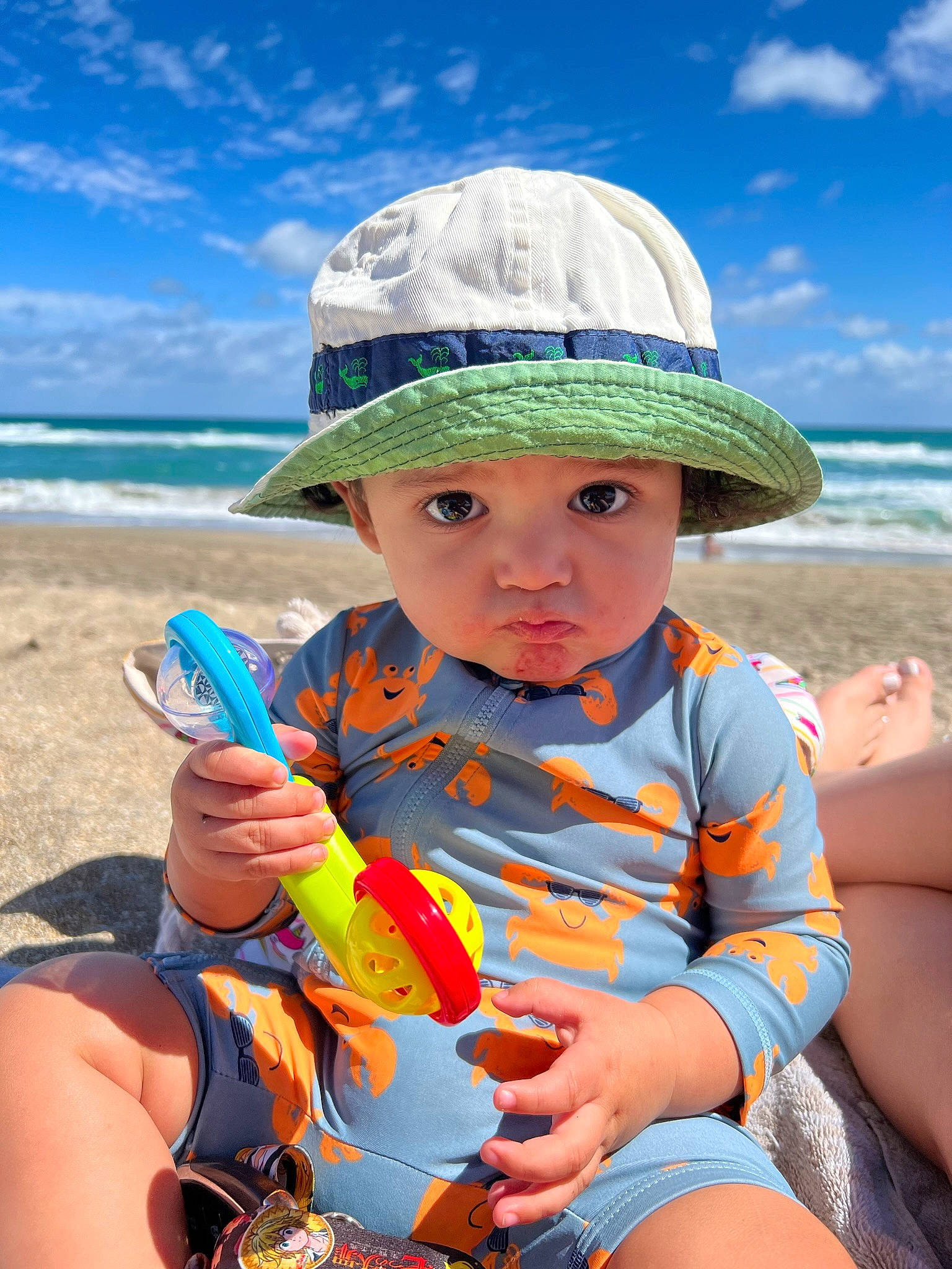 Gabriel joined the competition — help win amazing prizes! baby_toddler_clothing, beach, blue, cap, cloud, cool, fun, happy, hat, headwear, human_body, leisure, musical_instrument, people_in_nature, person, photograph, recreation, sky, sun_hat, toddler