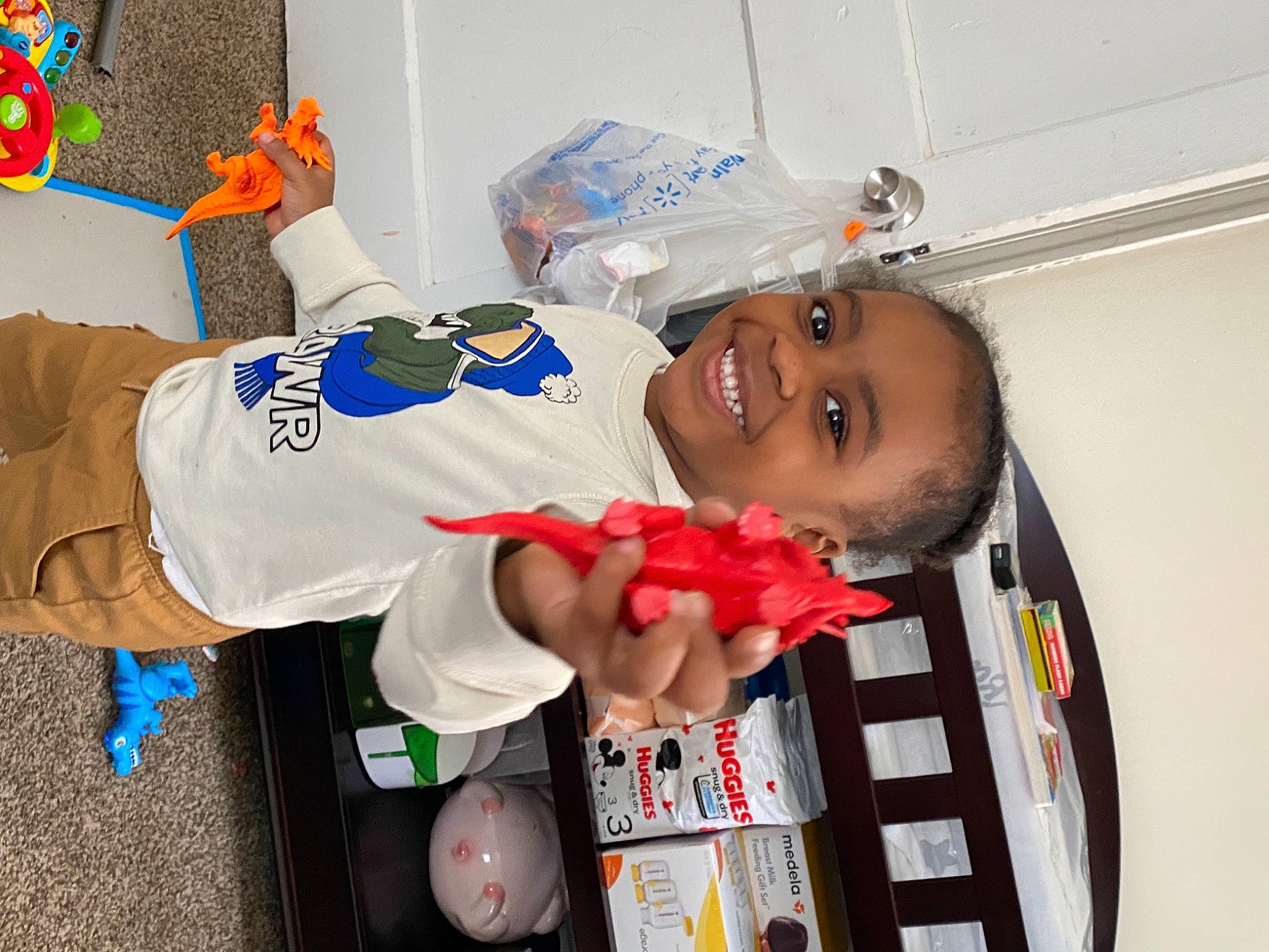 Marquis is registered to the contest to win money with this photo: arm, carmine, child, elbow, electric_blue, event, fun, gesture, happy, joy, person, room, smile, t_shirt, thumb, toddler