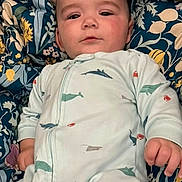 Grayson joined the competition — help win amazing prizes! baby, infant, onesie, shark_pattern, crab_pattern, blanket, floral_pattern, blue, comfort, lying_down, face, head, hand, expression, indoor, child, cute, portrait, young, soft