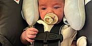 Grayson joined the competition — help win amazing prizes! baby, newborn, infant, pacifier, car_seat, safety_harness, buckle, head_support, warning_label, strap, hand, leg, clothing, plush, indoors, portrait, seat, sleepy, baby_accessory, closeup