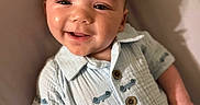 Grayson is registered to the contest to win money with this photo: baby, buttoned_shirt, child, clothing, comfort, cute, expression, face, furniture, happy, head, indoor, infant, light_blue, person, portrait, seated, skin, smiling, young_child