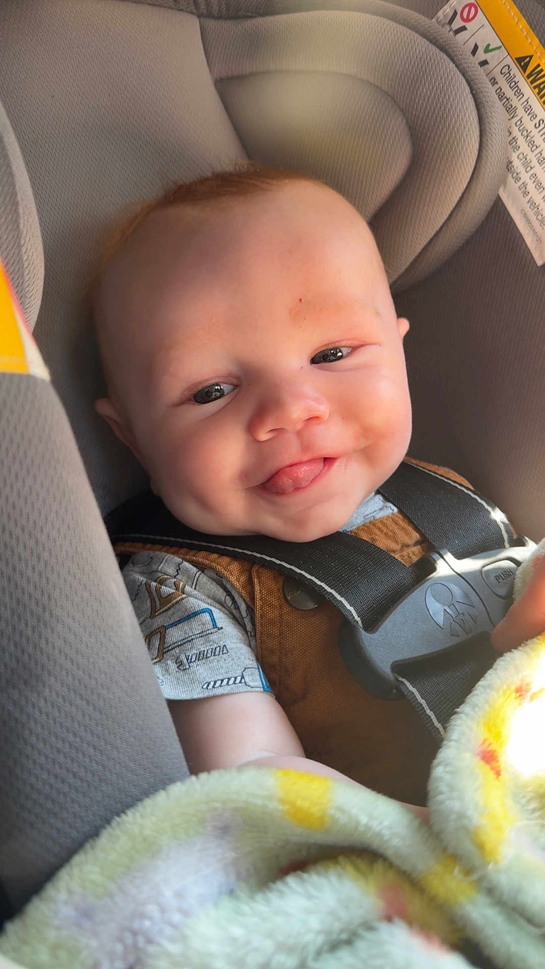 Elizah joined the competition — help win amazing prizes! baby, smiling, tongue_out, car_seat, blanket, child, seatbelt, happy, infant, clothing, closeup, face, head, indoors, person, cute, safety, seat, young, toddler