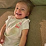 Caroline joined the competition — help win amazing prizes! toddler, child, smiling, happy, couch, clothing, white_shirt, stain, indoor, face, person, baby, infant, joy, relaxing, home, furniture, cute, portrait, casual