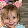 Caroline joined the competition — help win amazing prizes! child, smile, headband, pink, ears, indoor, blurry_background, playful, young_child, face, person, casual, happy, cute, hair, clothing, floor, toy, colorful, portrait