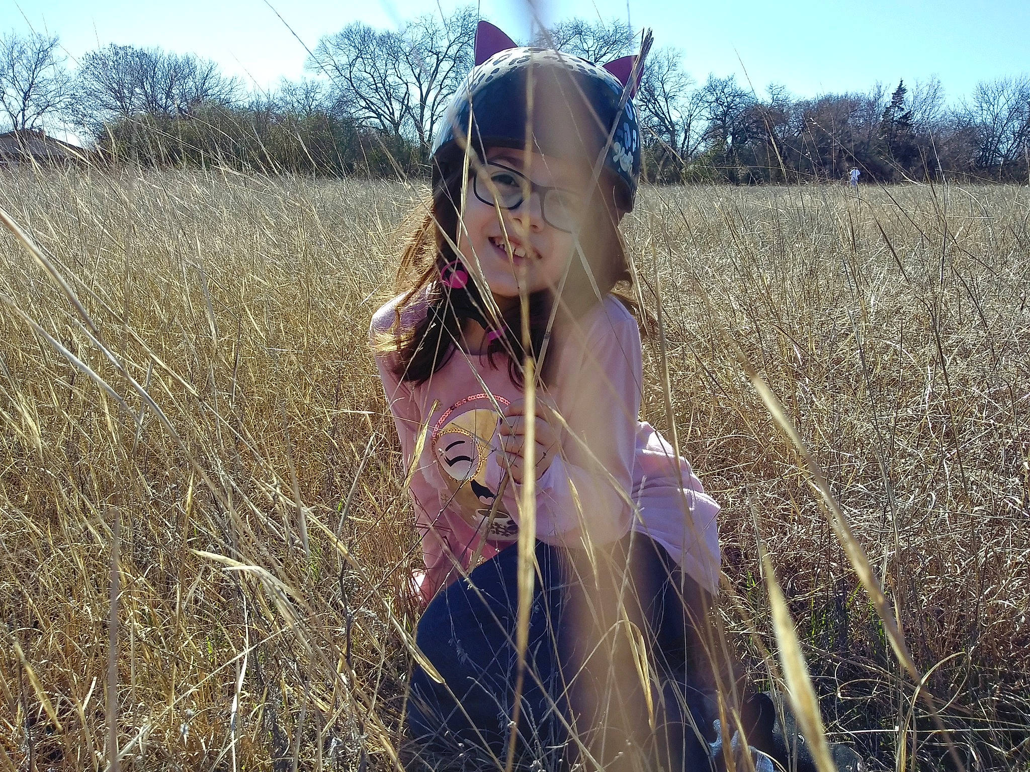 Olivia is registered to the contest to win money with this photo: agriculture, blond, brown_hair, fashion_accessory, fashion_design, fawn, field, fun, grass, grassland, happy, landscape, long_hair, meadow, people_in_nature, person, prairie, sky, sunlight, tree
