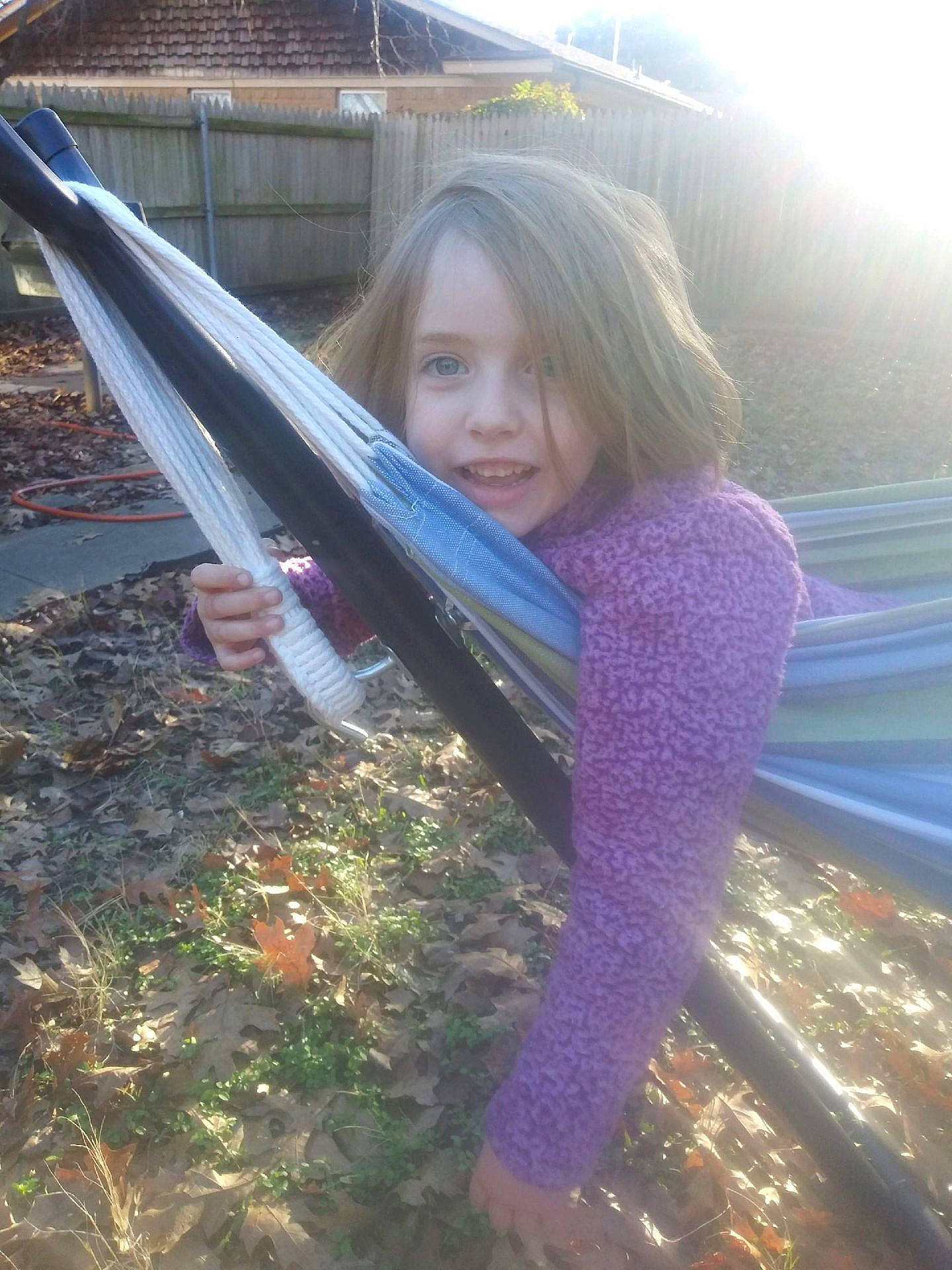 Peyton is registered to the contest to win money with this photo: automotive_exterior, blond, dress, face, forest, fun, grass, happy, leisure, long_hair, people_in_nature, person, plant, smile, sunlight, tints_and_shades, tree, vehicle_door, window, windshield