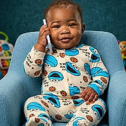 Jayson joined the competition — help win amazing prizes! baby, child, infant, portrait, smiling, sitting, armchair, pajamas, cookie_monster, blue, toy, nursery, indoors, face, hands, short_hair, happy, cute, photography, playful
