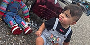 Lyam Carlo is registered to the contest to win money with this photo: toddler, child, barefoot, toy_car, chucky_doll, pavement, outdoor, cars, vintage_cars, overcast_sky, playful, tongue_out, shorts, tshirt, person, red_hair, doll, toy, parking_lot, expression