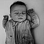 baby, sleeping, infant, arms_up, cozy, sleeping_bag, peaceful, face, portrait, monochrome, black_and_white, child, soft_texture, young, resting, closeup, indoors, cute, calm, newborn