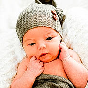 Jacob joined the competition — help win amazing prizes! baby, infant, newborn, hat, knitted_hat, blanket, wrapped, soft_texture, white_background, cute, face, hands, skin, closeup, portrait, resting, expression, cozy, warm, indoor
