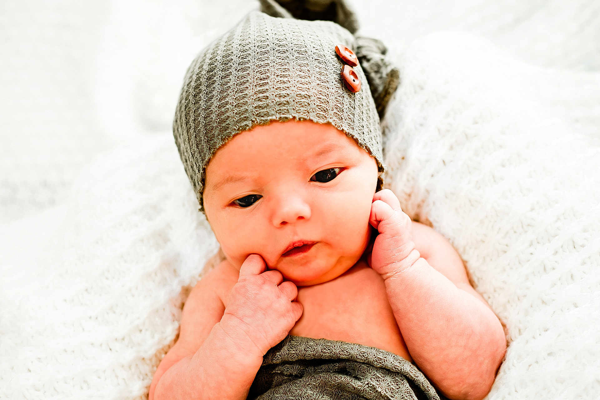 Jacob joined the competition — help win amazing prizes! baby, infant, newborn, hat, knitted_hat, blanket, wrapped, soft_texture, white_background, cute, face, hands, skin, closeup, portrait, resting, expression, cozy, warm, indoor