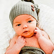 Jacob Carter is registered to the contest to win money with this photo: baby, infant, newborn, hat, knitted_hat, blanket, wrapped, portrait, close_up, soft_texture, cute, face, skin, hands, resting, cozy, warm, indoor, newborn_photography, cute_expression