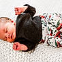 baby, newborn, sleeping, infant, blanket, knitted, clothing, sweater, pants, christmas_trees, red_cars, cozy, peaceful, cute, soft, portrait, resting, indoors, child, person