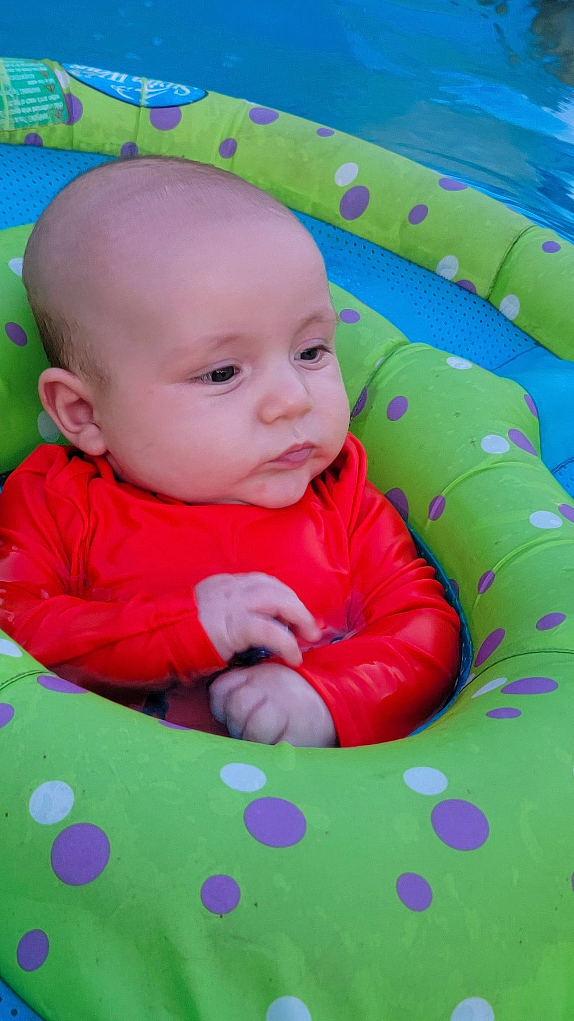 Eason is registered to the contest to win money with this photo: baby, baby_toddler_clothing, cheek, child, comfort, design, facial_expression, fun, grass, green, happy, linens, magenta, pattern, person, pink, skin, sleeve, smile, textile