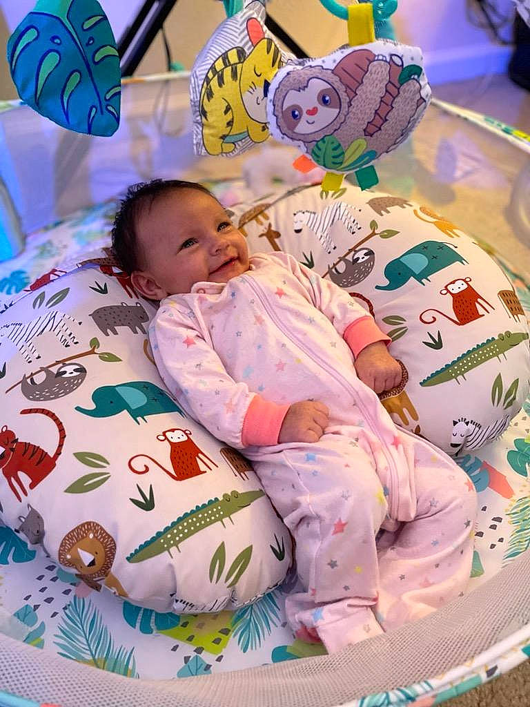 Amber is registered to the contest to win money with this photo: baby, baby_products, baby_toddler_clothing, bedtime, cheek, child, comfort, event, face, fun, happy, linens, mammal, person, pink, play, skin, textile, toddler, toy