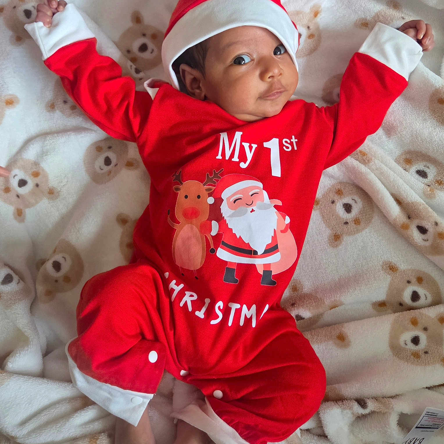 Jiraiya joined the competition — help win amazing prizes! baby, blanket, child, christmas, cozy, cute, face, feet, festive, holiday, holiday_clothing, indoors, infant, lying_down, newborn, portrait, red_outfit, santa_hat, smiling, teddy_bear_pattern