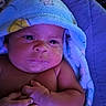 August is registered to the contest to win money with this photo: baby, infant, towel, blue, hands, face, skin, expression, portrait, newborn, closeup, child, cute, sleeping_area, soft, blanket, resting, indoors, person, wrapped