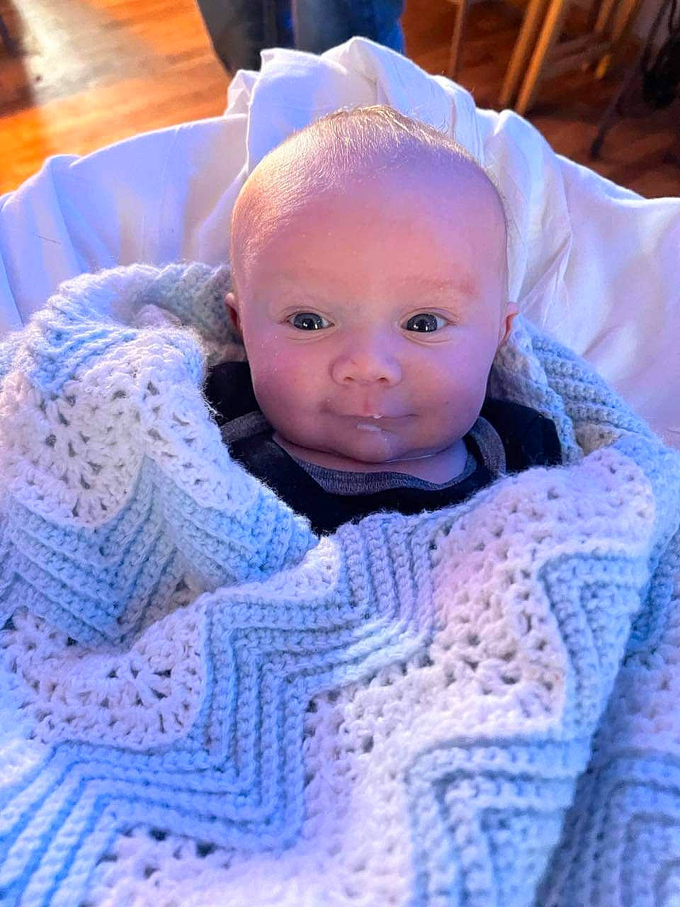 Mikah is registered to the contest to win money with this photo: art, baby, baby_toddler_clothing, blue, cap, cheek, child, craft, creative_arts, electric_blue, fashion_accessory, knit_cap, linens, pattern, person, purple, textile, toddler, wool, woolen