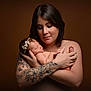 baby, newborn, woman, mother, tattoo, arm_tattoo, headband, skin, portrait, holding, love, family, infant, closeup, naked, peaceful, studio, brown_background, caring, tender