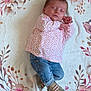 baby, sleeping, infant, jeans, floral_top, shoes, blanket, pattern, bird, flower, peaceful, cute, cozy, lying_down, child, small_shoes, soft_texture, nap, adorable, indoor