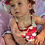 baby, child, infant, hat, floral_pattern, pink_cushion, cute, summer, outdoor, portrait, skin, eyes, hand, foot, sitting, clothing, earrings, sunlight, expression, closeup