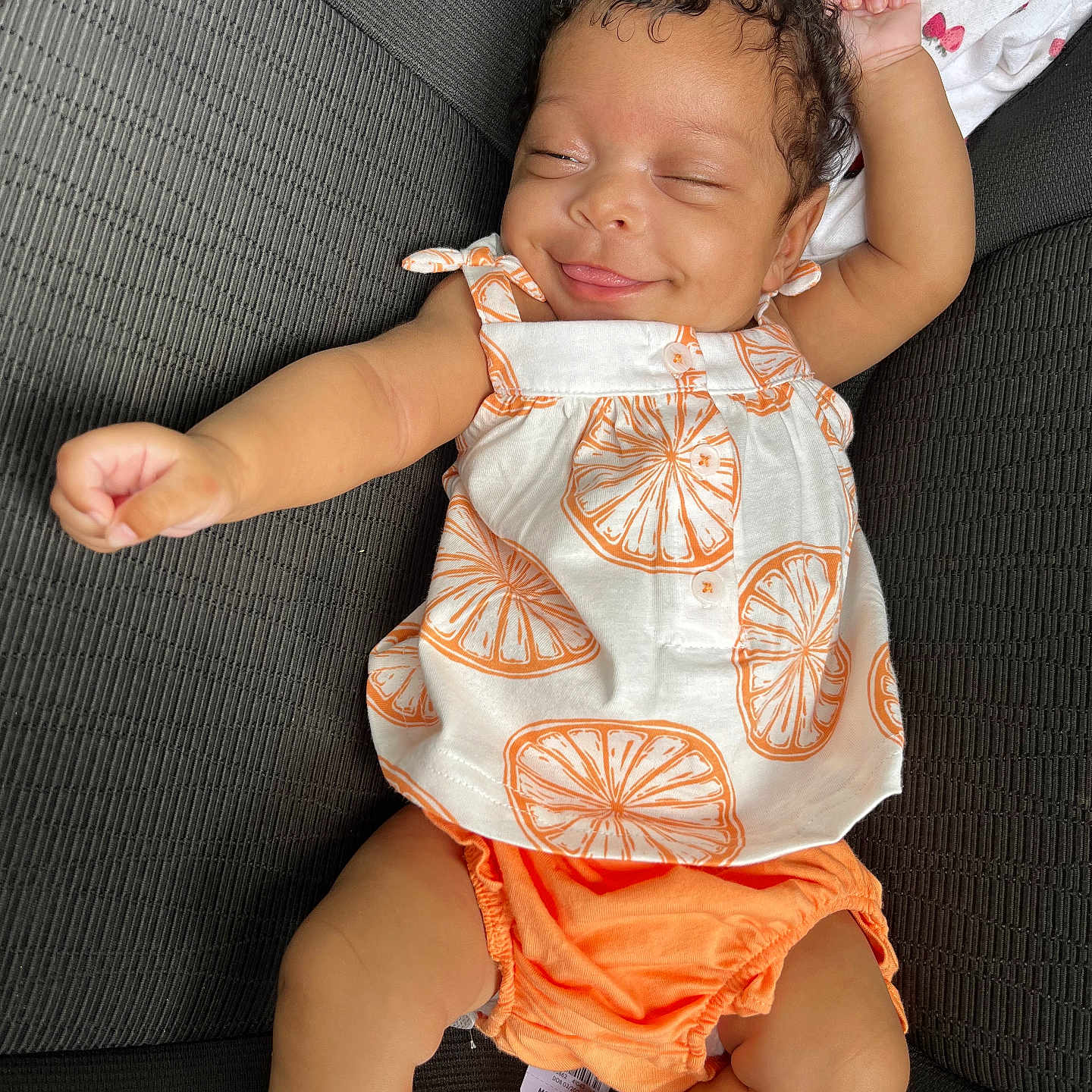 Janelle is registered to the contest to win money with this photo: baby, bodypart, clothing, couch, cushion, diaper, dress, face, finger, furniture, hand, head, homedecor, newborn, person, photography, portrait, shorts, sitting, sleeping