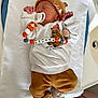 Mathis a rejoint le concours — aidez-le/la à gagner de superbes lots ! newborn, baby, sleeping, pacifier, beanie, sweater, bear_design, clothing, blanket, infant, cute, indoors, soft, peaceful, child, toy, person, resting, warm, casual