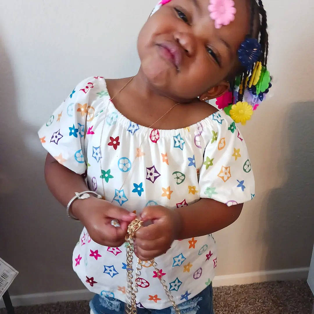 My'Ari joined the competition — help win amazing prizes! baby_toddler_clothing, elbow, eyelash, face, fashion, gesture, hand, happy, head, human_body, lip, mouth, neck, organ, person, pink, shoulder, skin, sleeve, smile