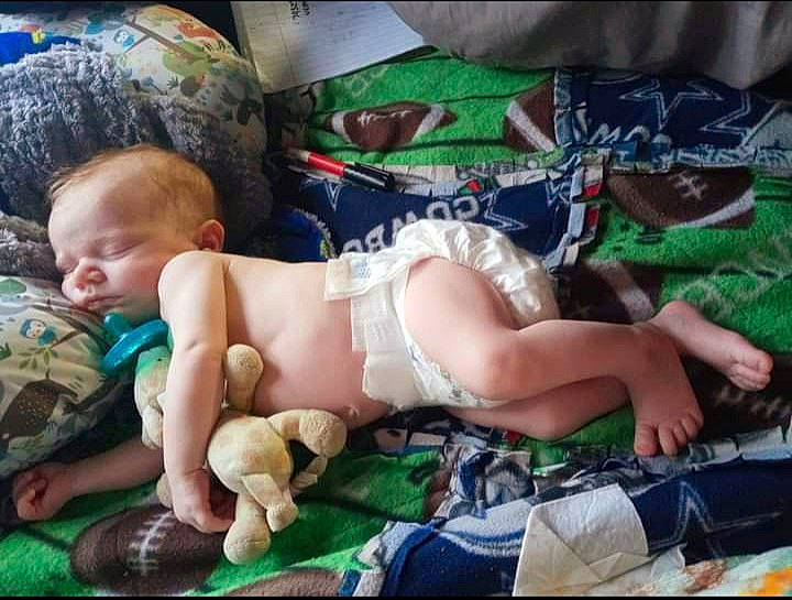 Zaine is registered to the contest to win money with this photo: abdomen, baby, baby_toddler_clothing, barechested, bedtime, chest, child, comfort, diaper, fun, grass, human_leg, knee, lap, linens, pattern, person, sitting, thigh, toddler