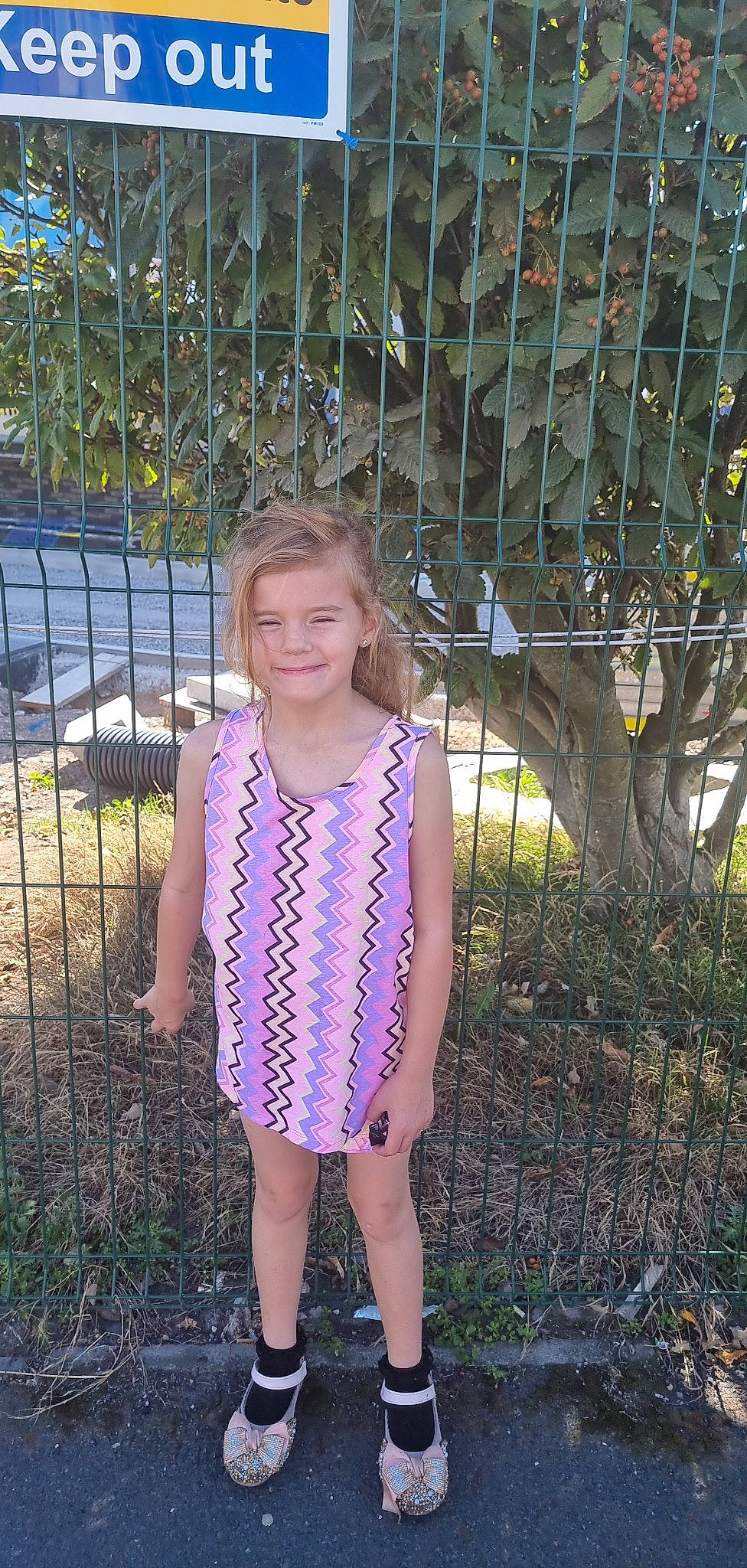 Lexi is registered to the contest to win money with this photo: baby_toddler_clothing, botany, day_dress, dress, electric_blue, eye, fawn, fence, fun, grass, happy, jewellery, joy, leaf, magenta, one_piece_garment, pattern, people_in_nature, person, plant