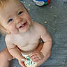 Mayrilda is registered to the contest to win money with this photo: baby, beach_ball, child, cookie, crumbs, diaper, floor, frosting, green_sprinkles, hands, happy, head, indoor, messy, person, playful, sitting, smiling, toy, young_child