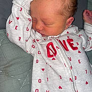 Paisley is registered to the contest to win money with this photo: newborn, baby, sleeping, onesie, love, heart, infant, cute, peaceful, soft, quilt, fabric, clothing, child, toddler, portrait, resting, person, hand, skin