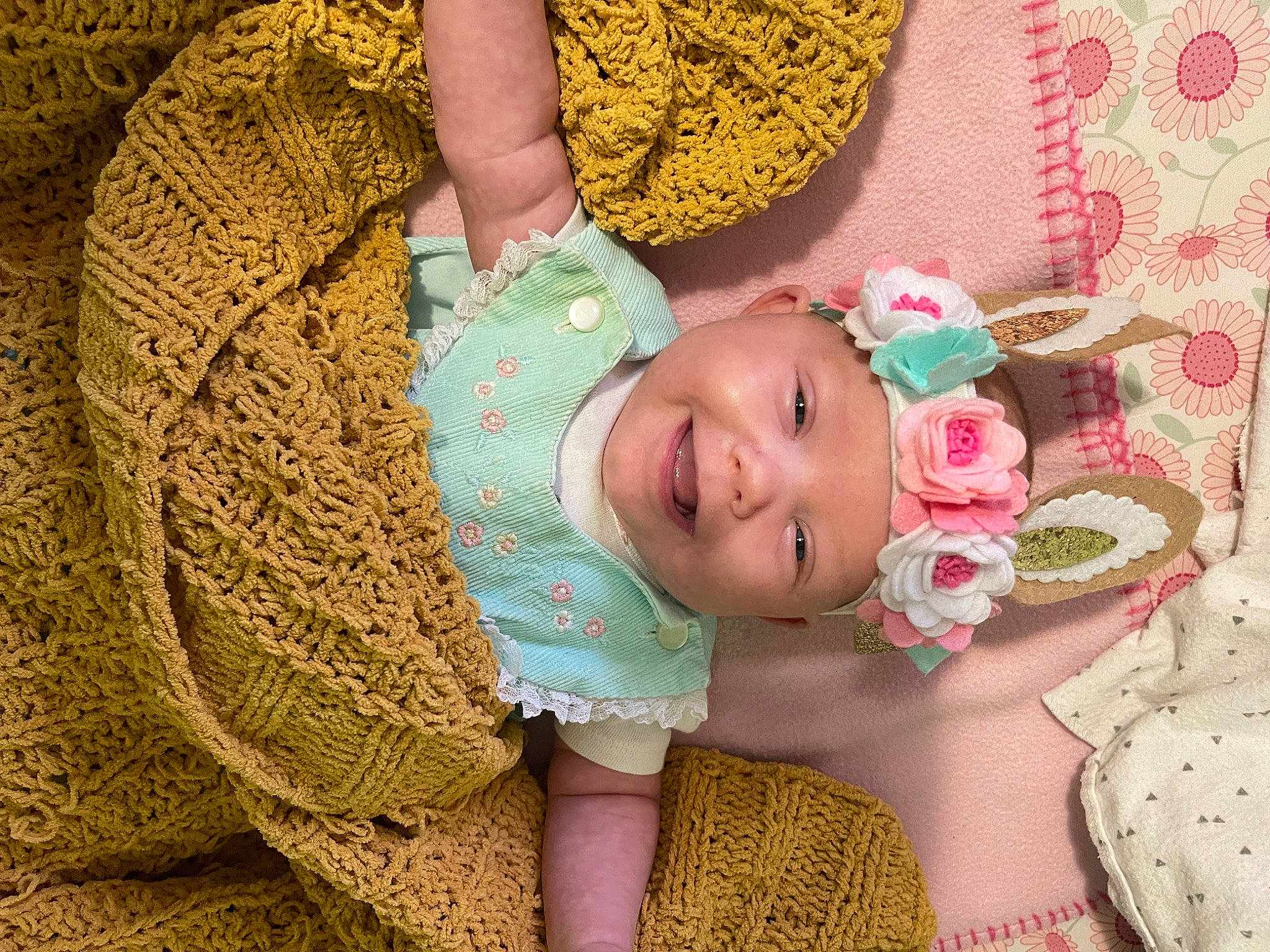 Calliope joined the competition — help win amazing prizes! baby, baby_products, baby_toddler_clothing, child, comfort, eyelash, finger, green, hair_accessory, happy, headgear, headwear, joy, linens, pattern, peach, person, pink, skin, smile