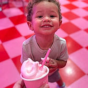 Dashane joined the competition — help win amazing prizes! child, toddler, smiling, curly_hair, ice_cream, cup, pink, floor, checkered_floor, red, pink_floor, shoes, clothing, indoor, person, happy, food, dessert, hand, closeup