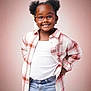 bow, child, cute, earrings, eyewear, fashion, girl, glasses, hair_buns, hands_on_hips, happy, jeans, pink_background, plaid_shirt, portrait, pose, smile, studio_background, white_tshirt, young