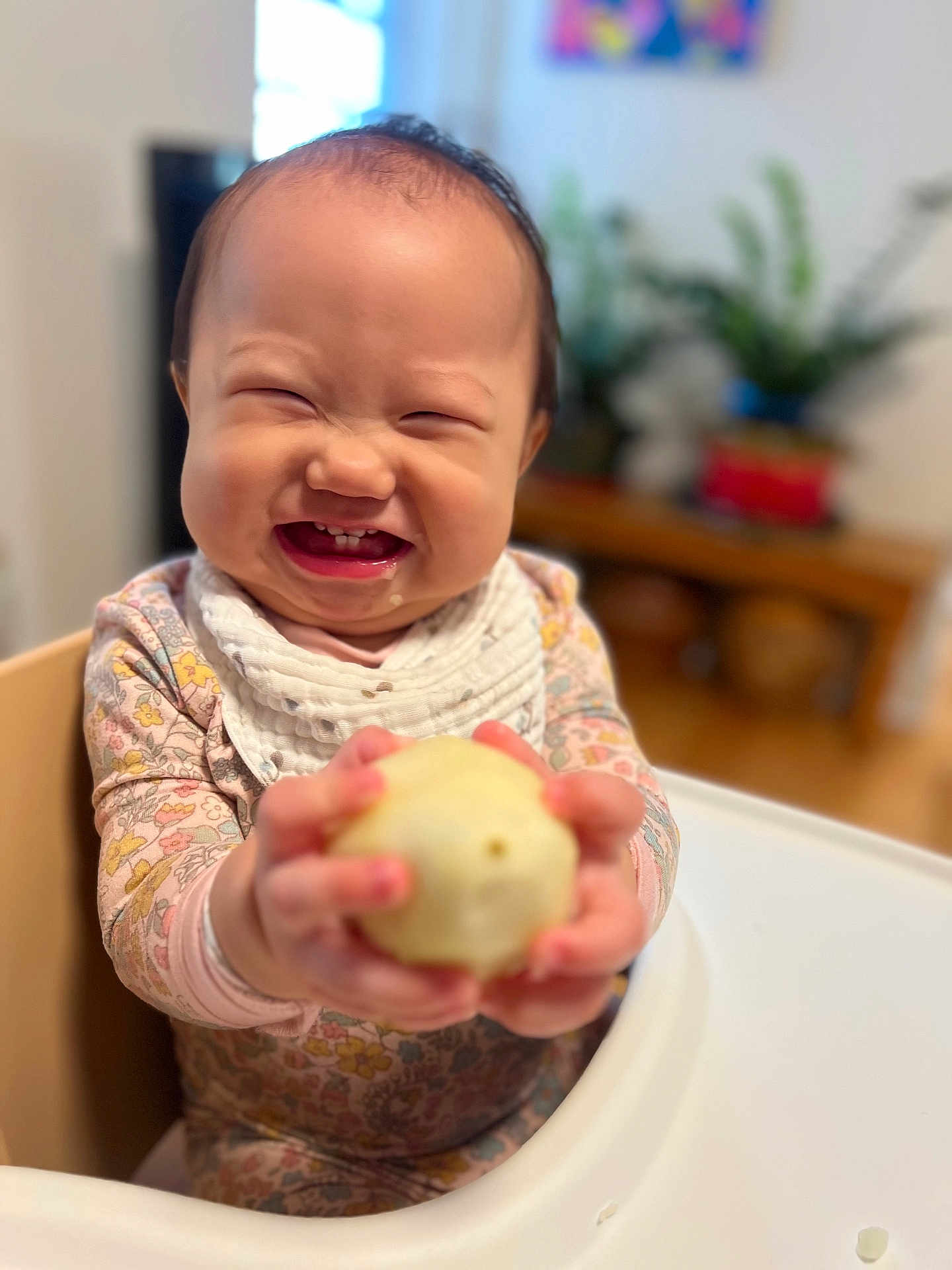 Lumi joined the competition — help win amazing prizes! baby, bib, child, clothing, cute, expression, face, food, furniture, hand, happy, high_chair, holding, home, indoor, infant, person, smile, snack, table