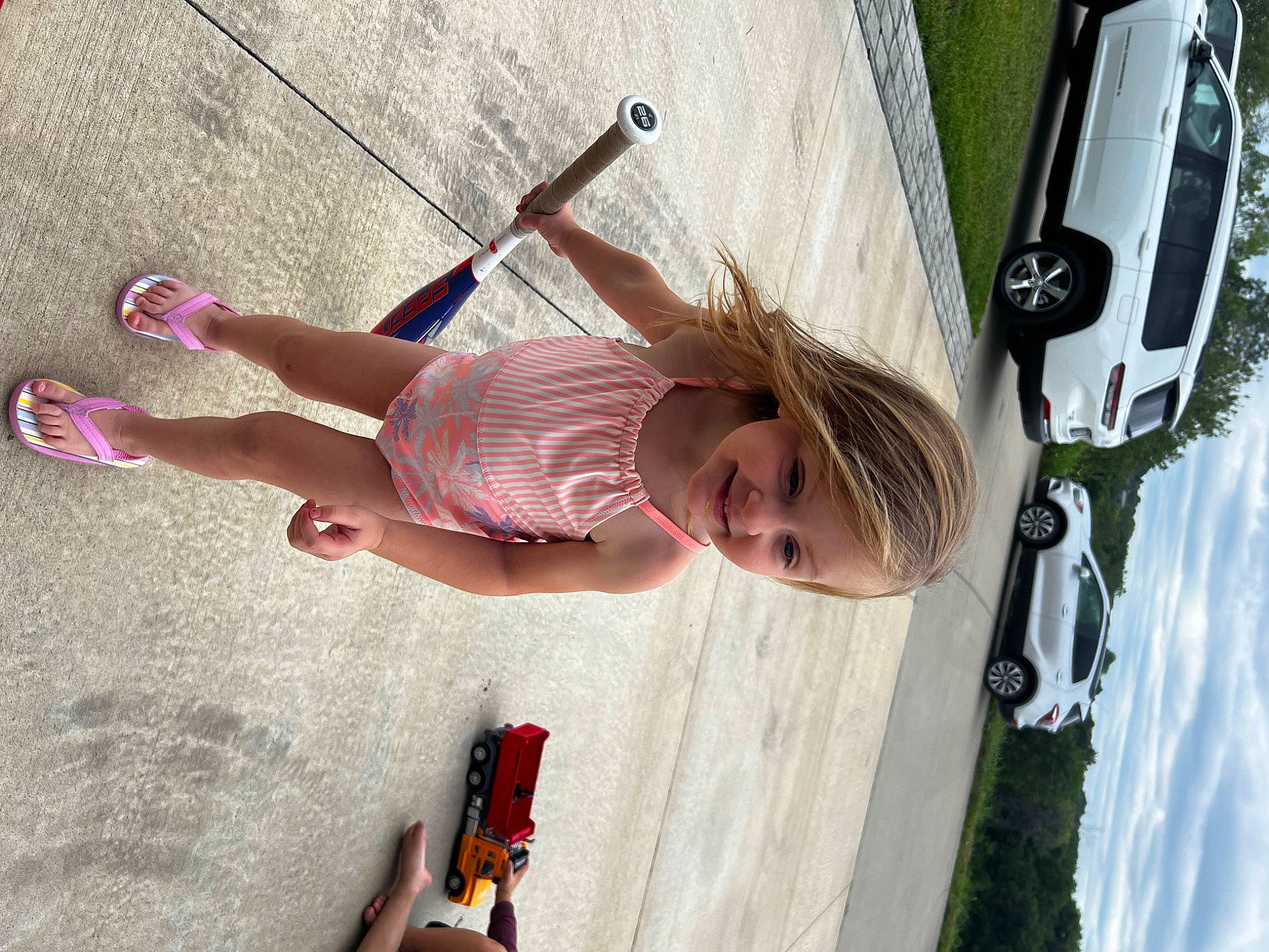 Kinzley is registered to the contest to win money with this photo: automotive_exterior, automotive_lighting, automotive_tire, car, child, fun, human_leg, joy, leisure, light, person, pink, recreation, snapshot, thigh, tire, toddler, vehicle, vehicle_door, wheel