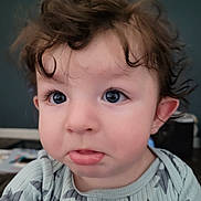 Damon joined the competition — help win amazing prizes! child, toddler, baby, face, eyes, curly_hair, hair, onesie, star_pattern, close_up, portrait, indoors, pout, cheeks, ear, mouth, long_eyelashes, skin, expression, soft_lighting