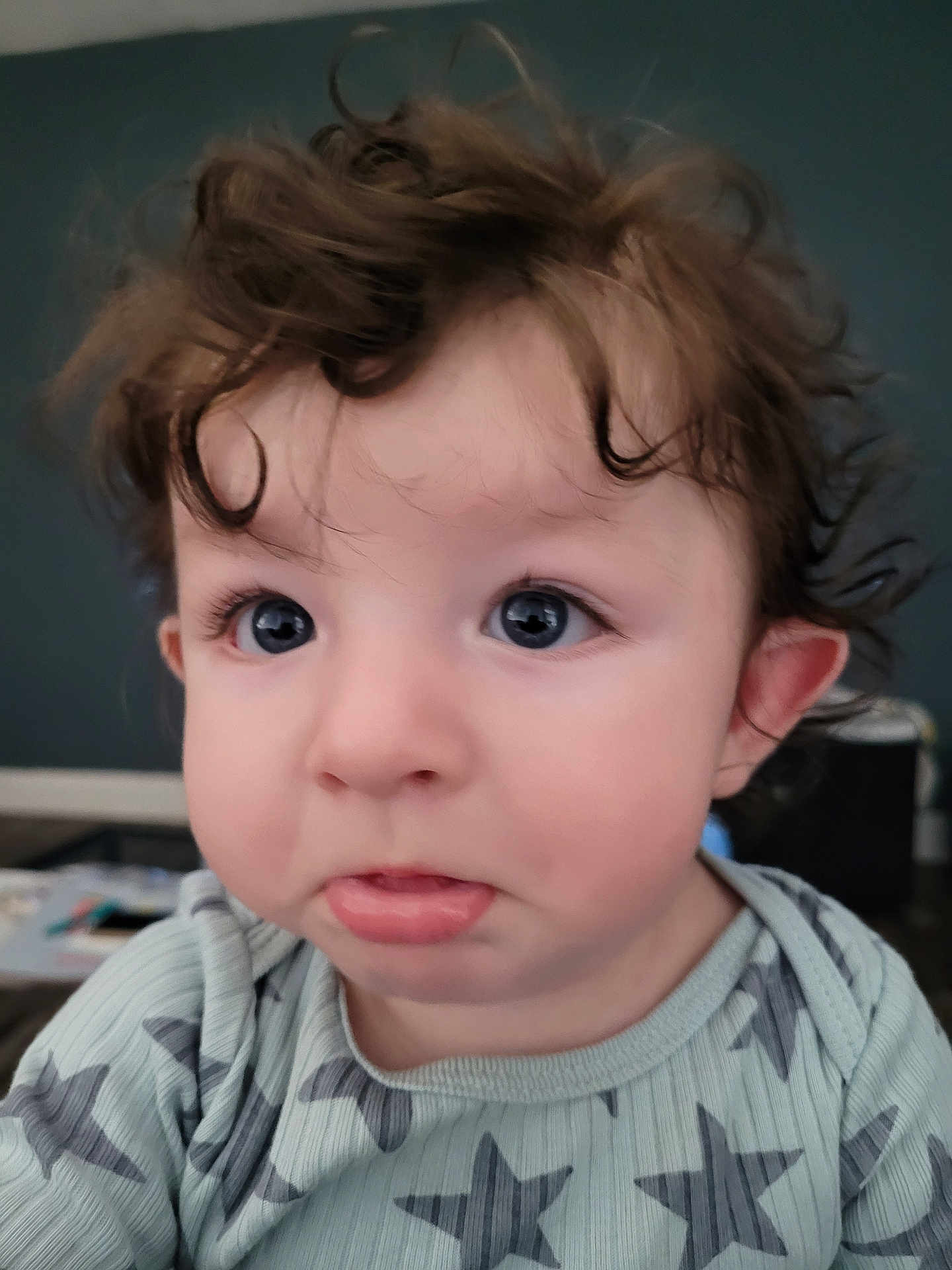 Damon joined the competition — help win amazing prizes! child, toddler, baby, face, eyes, curly_hair, hair, onesie, star_pattern, close_up, portrait, indoors, pout, cheeks, ear, mouth, long_eyelashes, skin, expression, soft_lighting