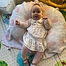 baby, balloon, celebration, child, cushion, cute, dress, footwear, happy, headband, heart_pattern, indoors, infant, lying_down, pink, play_mat, shoes, smiling, toddler, toy