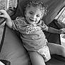 Denver is registered to the contest to win money with this photo: child, toddler, smiling, curly_hair, tshirt, diaper, chair, outdoor, porch, relaxing, happy, person, casual, seat, baby, clothing, legs, hand, fabric, daylight
