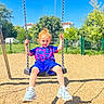 Noyan-Latif a rejoint le concours — aidez-le/la à gagner de superbes lots ! child, swing, playground, outdoor, sunny, blue_sky, trees, greenery, woodchips, shadow, red_hair, curly_hair, holding_chains, sneakers, shorts, tshirt, happy, smiling, daytime, recreation