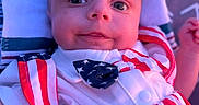 Asaiah joined the competition — help win amazing prizes! baby, infant, child, face, portrait, clothing, stars_and_stripes, red, white, blue, bow_tie, cushion, pillow, smile, outdoor, closeup, cute, young, person, fashion